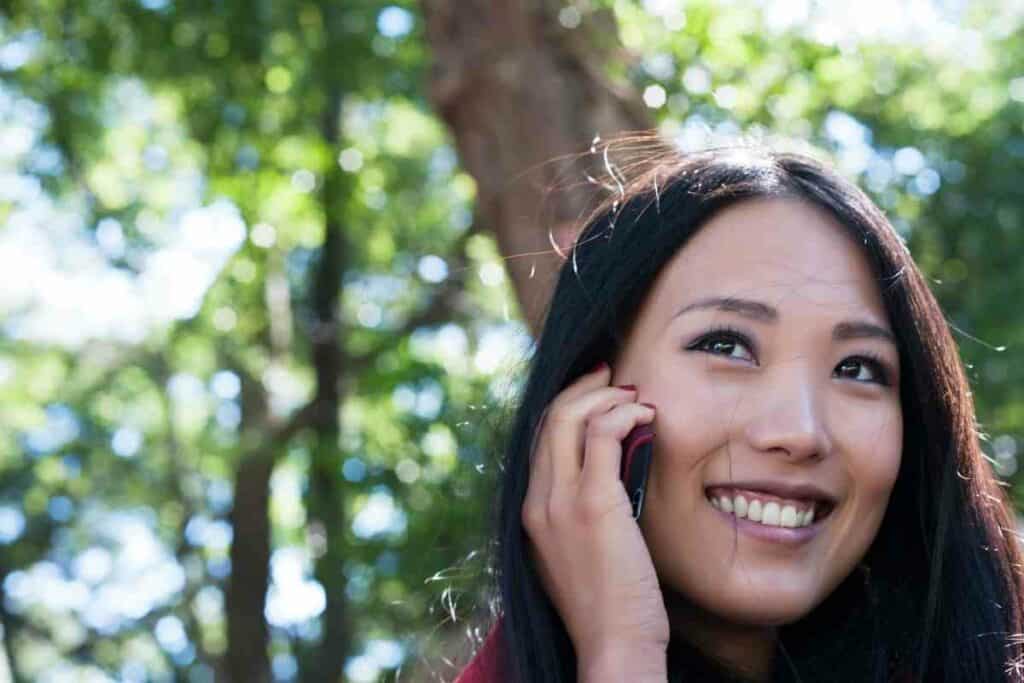 Japanese girl with brown eyes on her phone