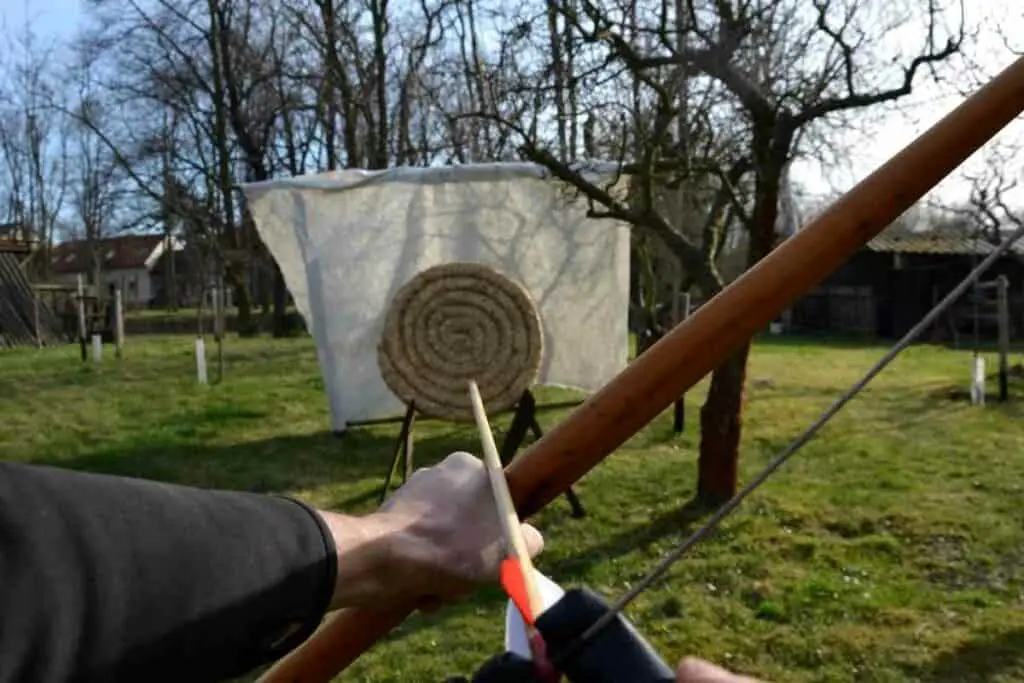 Practicing longbow in backyard