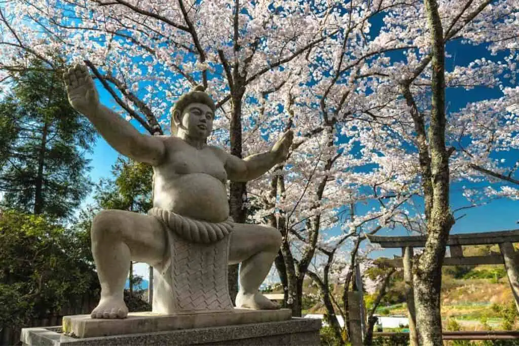 Sumo wrestler statue in a park