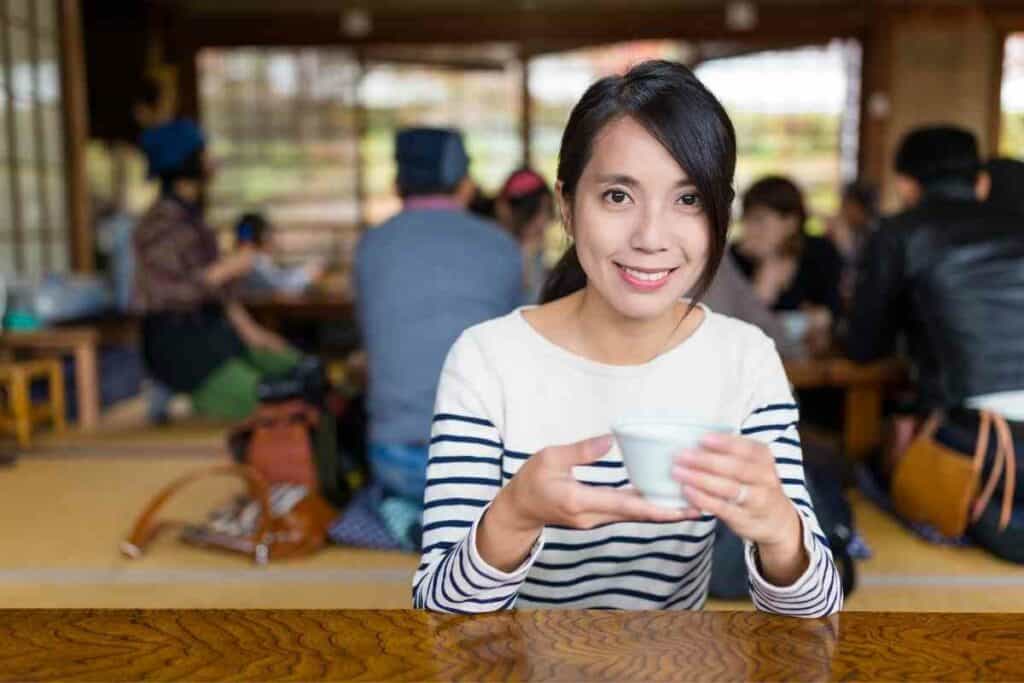 Woman is drinking Hojicha tea